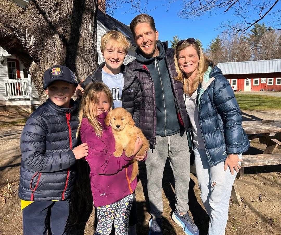 Family with golden retriever on the porch